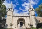Main entrance gate of Topkapi Palace in Istanbul with two conical towers and Ottoman ramparts