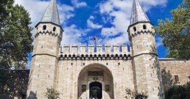 Main entrance gate of Topkapi Palace in Istanbul with two conical towers and Ottoman ramparts