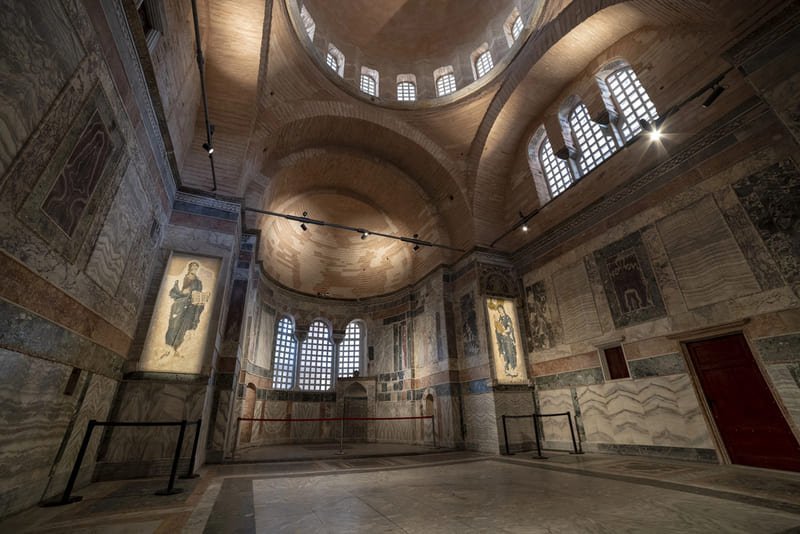 Je contemple l'intérieur de l'église Chora à Istanbul, un édifice byzantin du XIe siècle avec ses coupoles, ses fenêtres à claire-voie, ses icônes dorées et ses murs en marbre patiné.